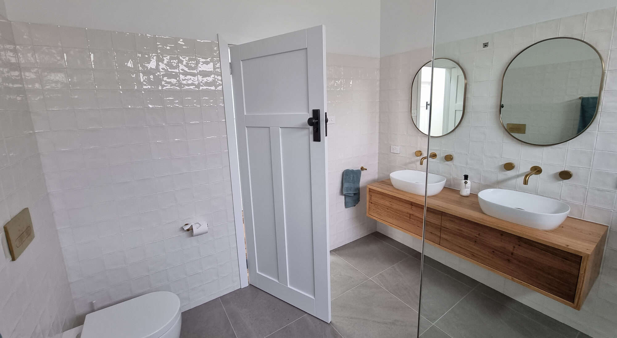 bathroom with wooden vanity looking from over bathtub