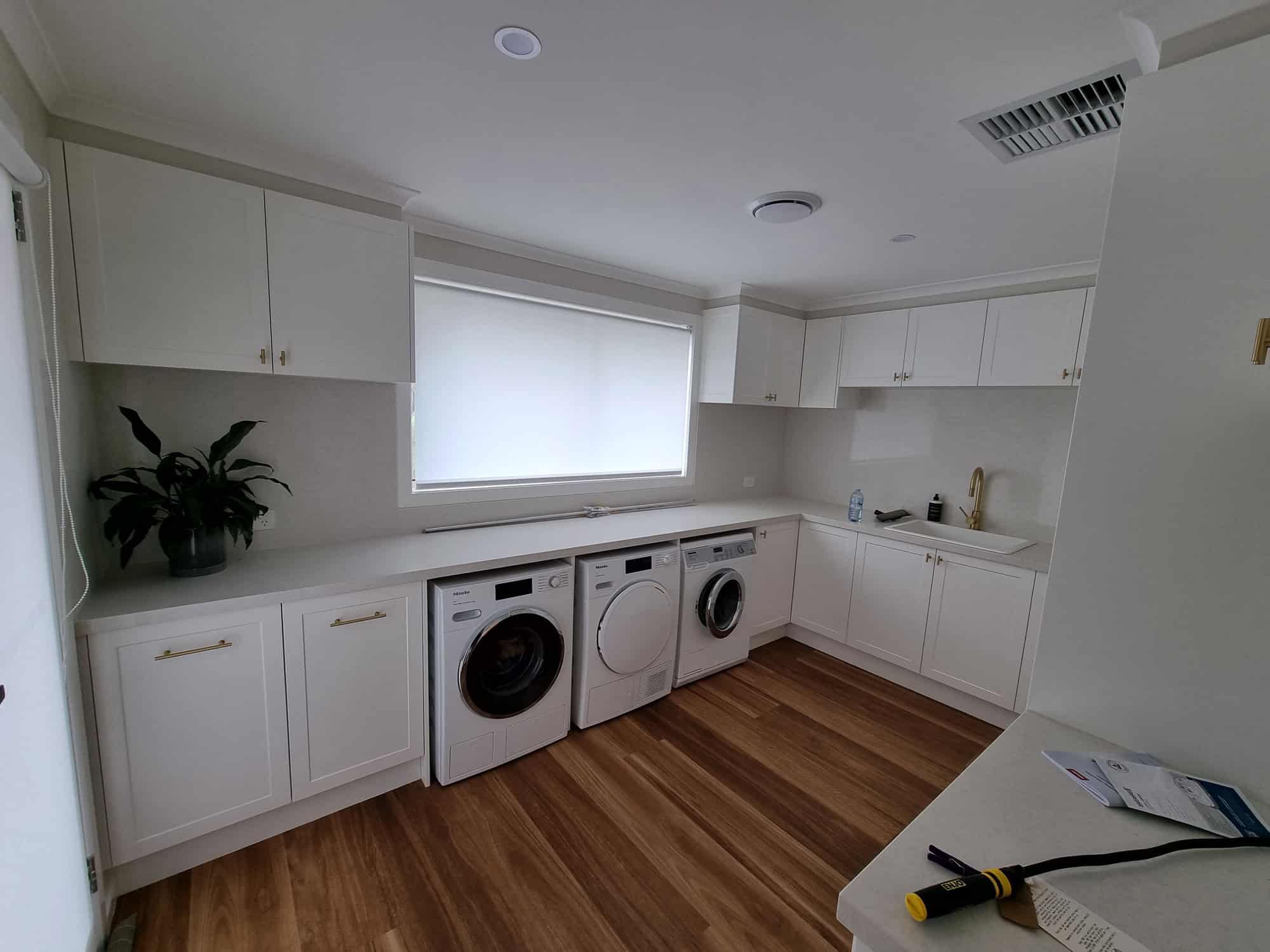 laundry looking at appliances with all white cabinetry